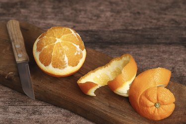 A peeled orange on the wooden background.