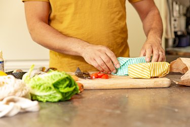 Shot of hands wrapping sandwiches in beeswax