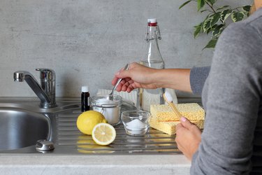 Preparing a natural non-chemical sink cleaner at home with baking soda and vinegar