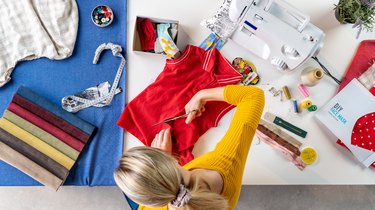 Top view of woman sewing face masks from T-shirt