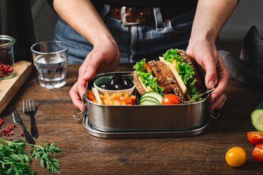 Closeup of a woman making a healthy lunch box