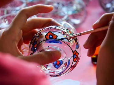 Close-Up Of Hands Painting Glass Container