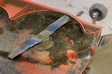 Dirty lawn mower deck. Concept of lawn equipment repair, maintenance and service