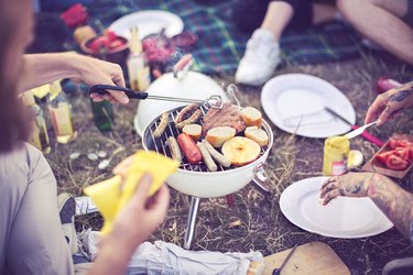 Man cooking food over a barbecue