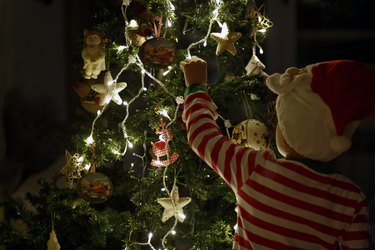 Boy decorating the Christmas tree