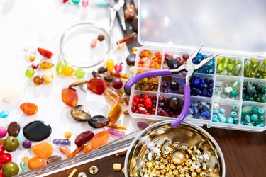 Close-Up Photo of Multiple Colored Beads With a Pair of Needle Nose Pliers