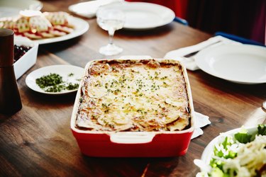 Roasted scalloped potatoes in pan on table for holiday meal