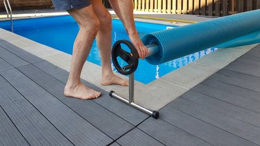 Man rolling pool cover