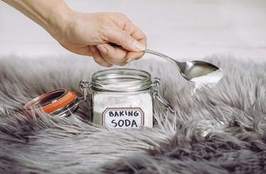 Hand pouring baking soda