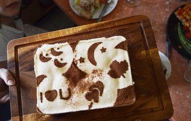 Tiramisu Decorated With Drawings Stencil Of Cocoa On Dark Wooden Board