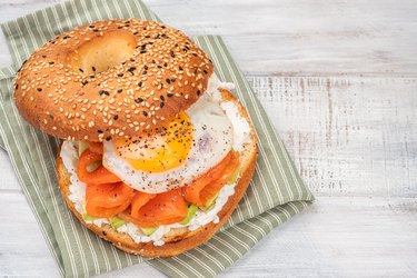 Bagel sandwich with salmon, cream cheese, avocado and egg.