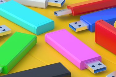 Scattered flash drives, USB memory sticks on yellow surface