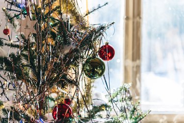 festive decorated christmas tree in front of the window