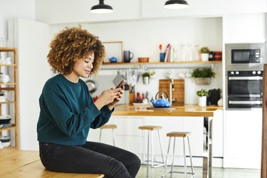 African American Woman Surfing Social Media at Home.