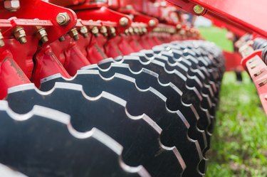 Close up thick agricultural metal wheels disks