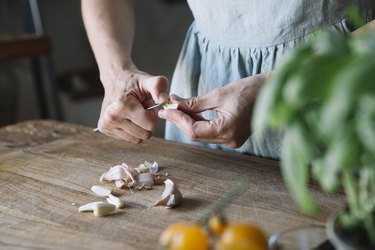 Close-up of woman peeling garlic