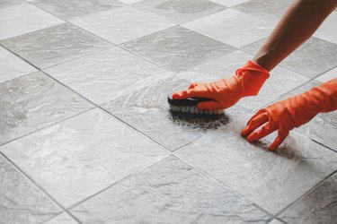 Hands cleaning tiled floor