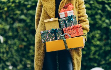 Woman holding Christmas gifts.