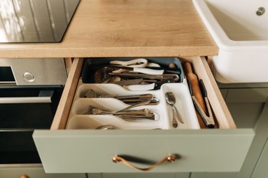 Set of clean kitchenware and utensils in drawers