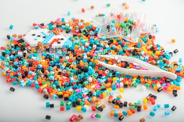 Perler beads and other supplies on table