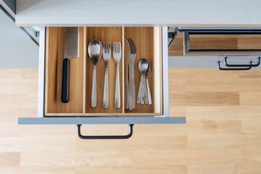 Wooden kitchen drawer organizer in open drawer, top view