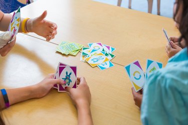 School children playing card game