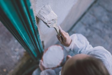 Woman painting a wall