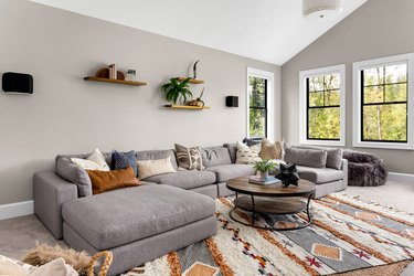 Beautiful living room interior with colorful area rug, large couch, and abundant natural light