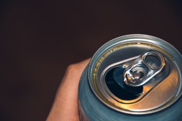 Close-Up Of Hand Holding Aluminum Can