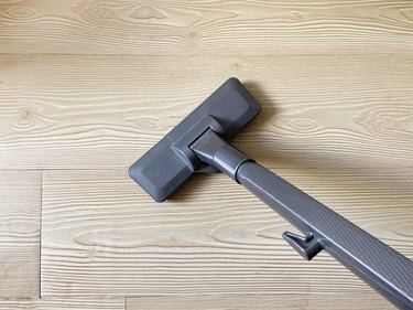 Vacuum cleaner on the parquet floor