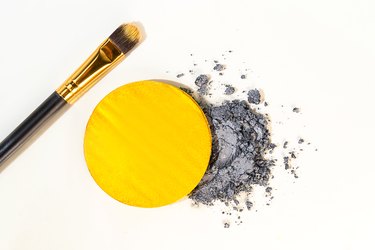 Beauty set of gray and bright illuminating yellow eyeshadows or face paint