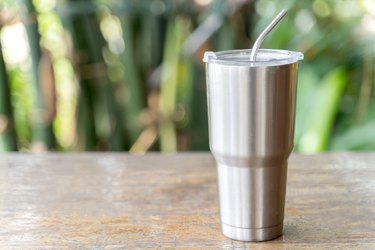 Stainless steel tumbler with stainless straw keeping of the drink cold or hot. Reduce plastic pollution concept.