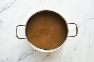 Vegetable stock in the pot on white background