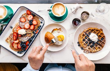 Man eating breakfast at the cafe, personal perspective POV