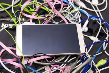 Smartphone with tangled, multicolor wires and cables