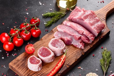 Fresh pieces pork ready to cook on a dark background