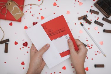 Close up of woman writing Valentine card