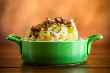 Mashed potatoes topped with bacon and onions