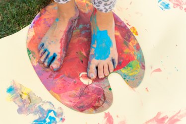 Painted feet on a colorful painting palette
