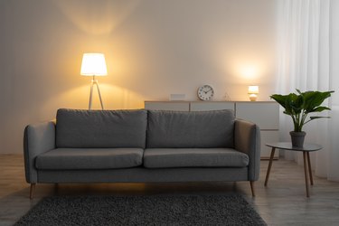 Glowing lamp behind couch