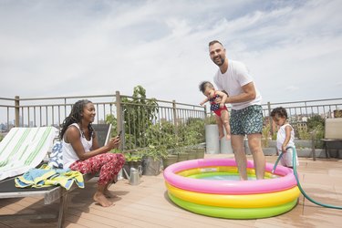 Family playing in an inflatable swimming pool