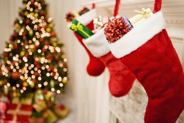 Christmas stockings hanging, Christmas tree in background, close-up