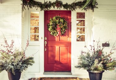 Exterior red door decorated for Christmas