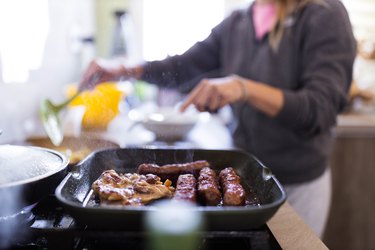 Close up of grilling meat in frying pan.