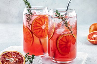 Blood orange margarita cocktail with ice and thyme