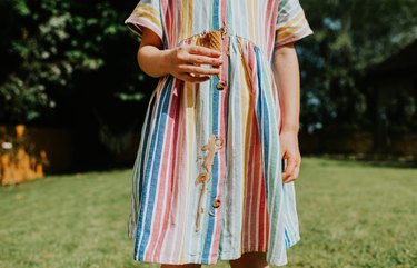 Girl dripping ice cream on her linen dress