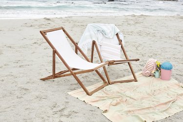 Empty sun loungers on the beach with towels and toys