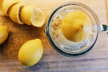 Lemons and lemon squeezer on table