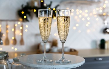 Glasses with champagne on the background of christmas decorations.