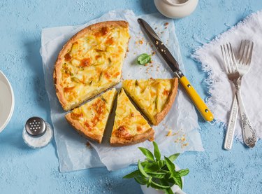 Leek, potato and cheese pie on a blue background